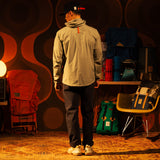 General back image of a man wearing a global jacket in "Oil Green" [Model is 5'11", wearing size medium]