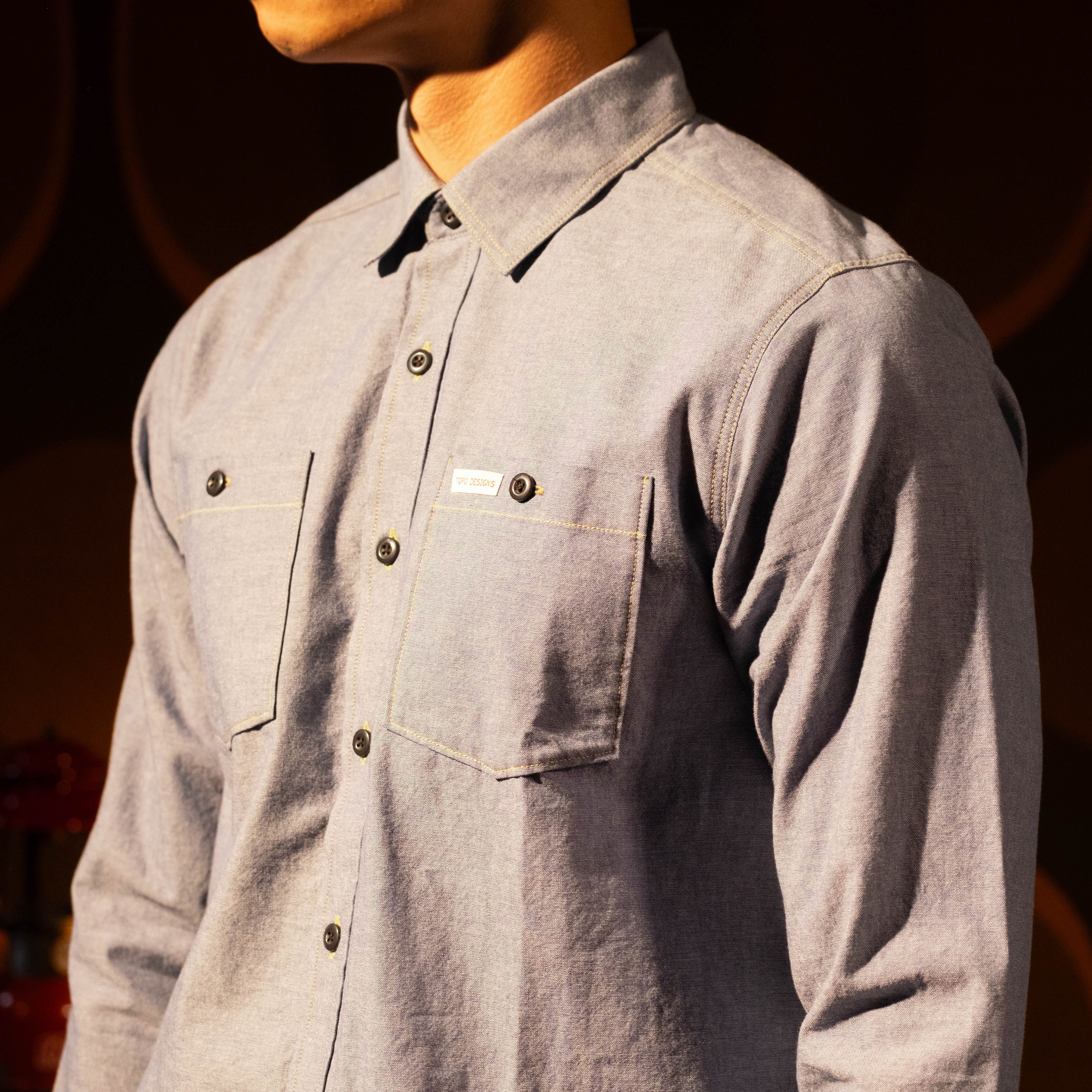 General lookbook photo of model wearing Topo Designs Utility Shirt - Men's in "Blue Chambray" [Model is 5'11", wearing size medium]