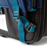 General shot of backpack strap attachment points on Topo Designs Global Travel Bag Roller durable carry-on convertible laptop rolling suitcase in Navy blue.
