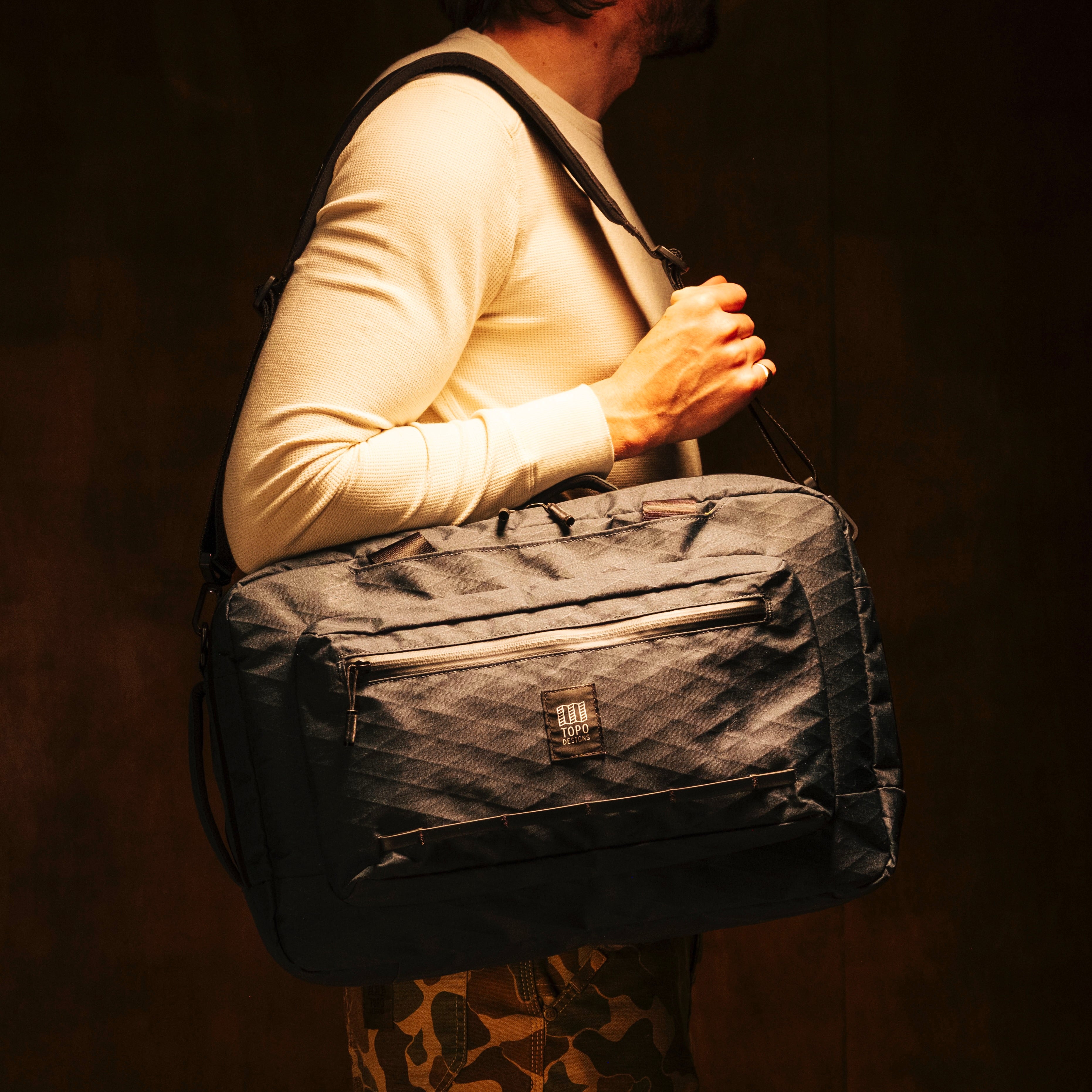 General shot of Topo Designs Global Pro 3-Way Briefcase in studio setting showing over the shoulder strap