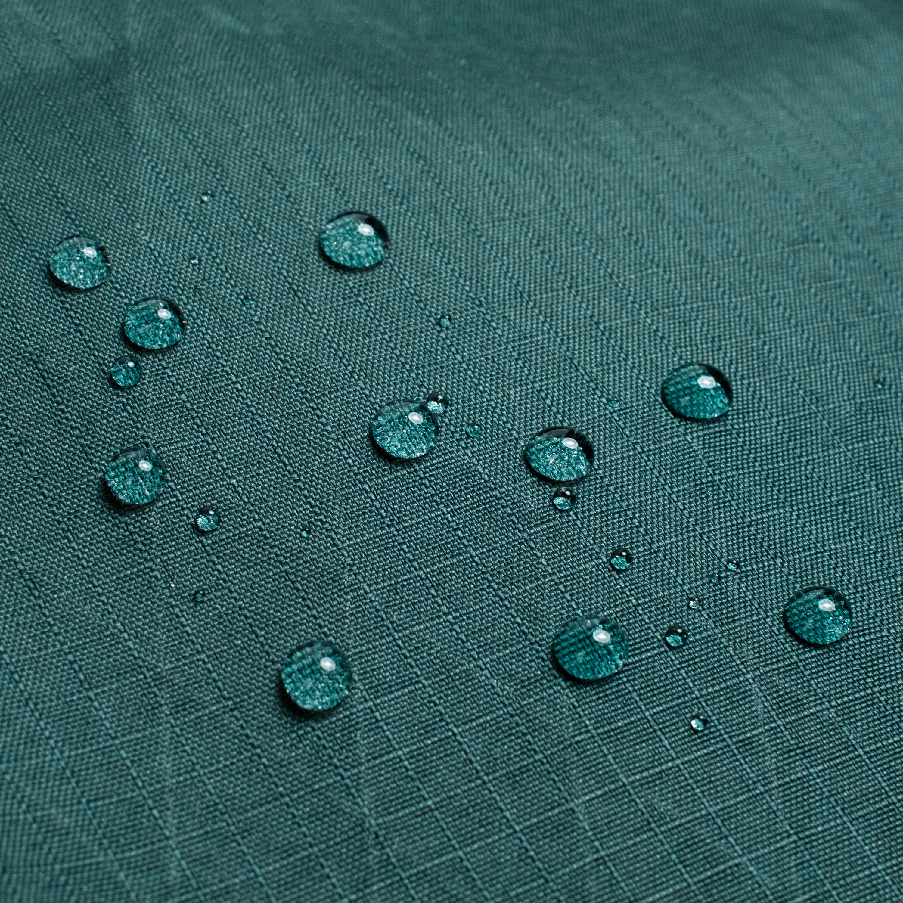 General back shot of Topo Designs Global Pro Travel Roller Bag showing water droplets on waterpoof material