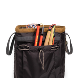 General detail shot of Topo Designs Mountain Gear Bag in "Black / Neutral" with side pocket packed out.