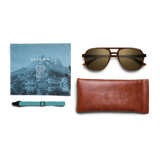 General view of VALLON X Topo Designs sunglasses in "Brown / Brown" with microfiber cloth, leather sunglasses case, and sunglasses strap.